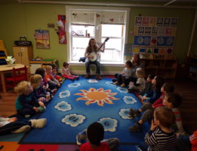 Miss Lisa plays the banjitar as the Coddington Road Community Center in Ithaca celebrates Music Monday for Week of the Young Child