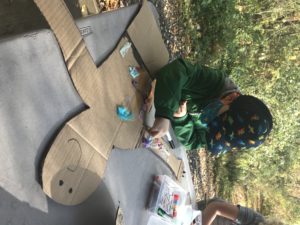 The Bear Room students at the Coddington Preschool Program enjoy arts and crafts outside