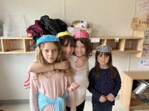 Photograph of a group of children posing for the camera wearing their homemade brain hats.