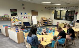 Photo shows the Bear Room classroom at Ithaca College with students and teachers