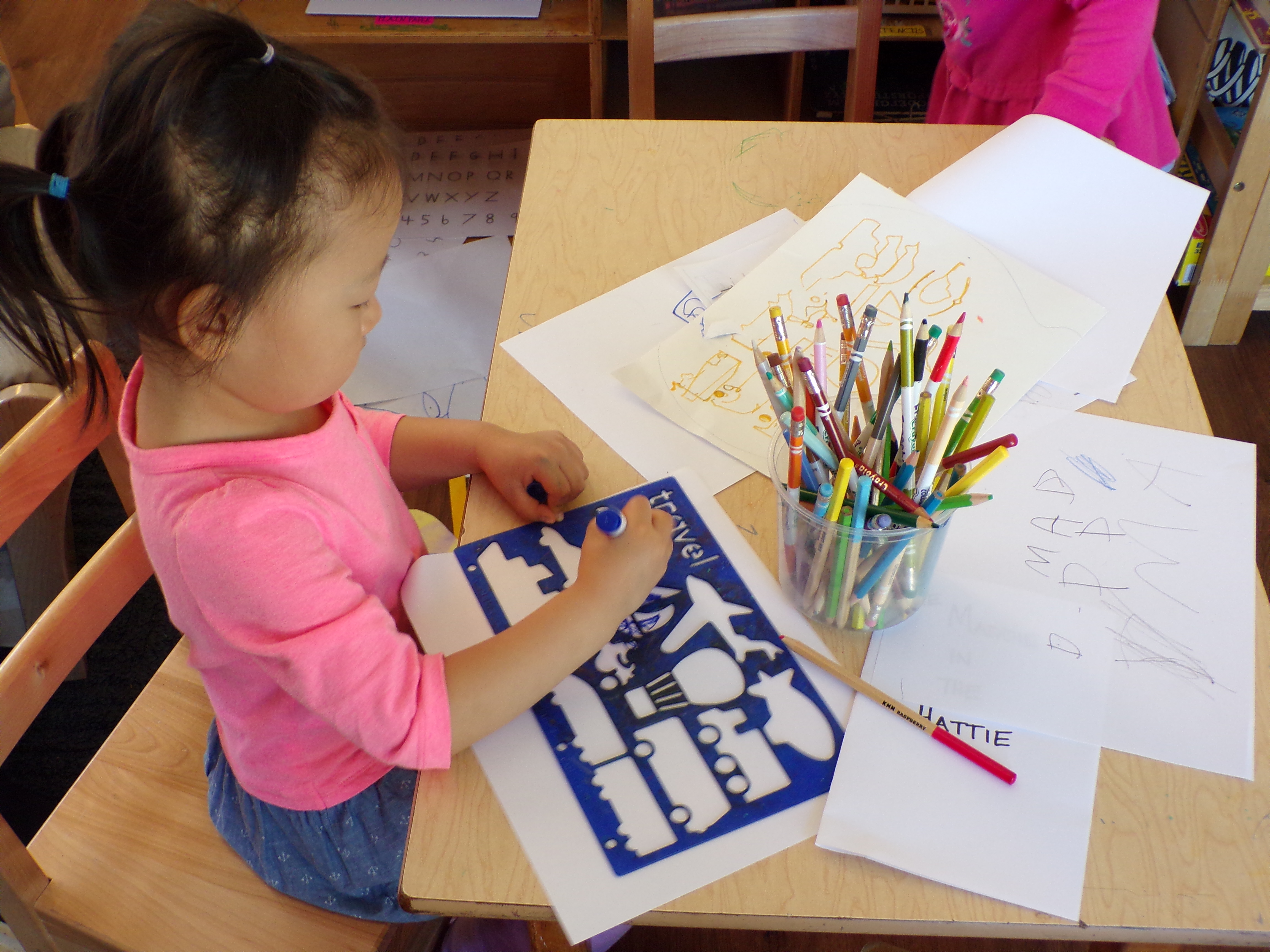 A preschool drawing a picture at the Coddington Road Community Center preschool in Ithaca